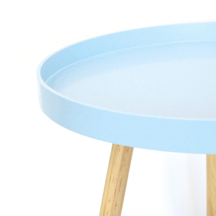 Round coffee table with light blue wooden legs